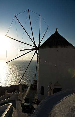 windmill on santorini island on sunset