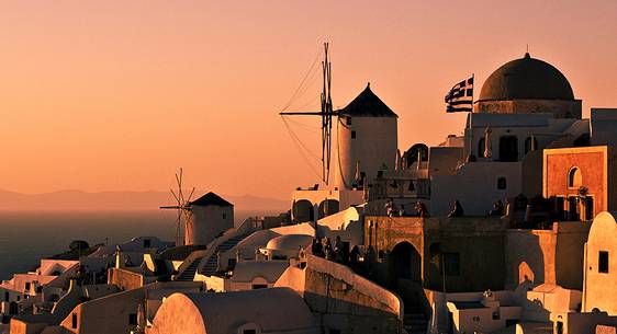 windmill on santorini island on sunset