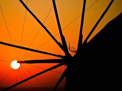 windmill on santorini island on sunset