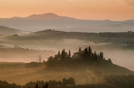 sunrise over the Crete Senesi in a misty morning