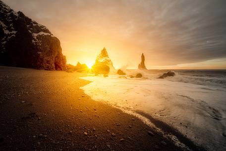 The black sand beach of Reynisfjara and the mount Reynisfjall from the Dyrholaey promontory in the southern coast of Iceland, Vik