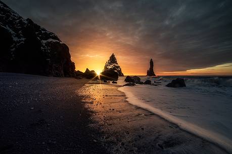 The black sand beach of Reynisfjara and the mount Reynisfjall from the Dyrholaey promontory in the southern coast of Iceland, Vik