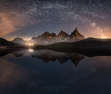 Starry over Segantini refuge and Pale di San Martino mountains, dolomites, Italy