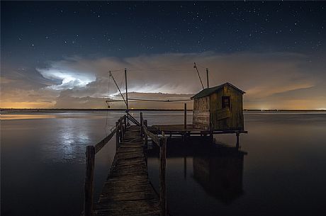 Lightning over Adriatic Sea with typical fishing house in Marina di Ravenna, Emilia Romagna, Italy, Europe