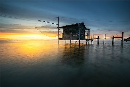 Typical fishing house in the adriatic coast at sunset, Marina di Ravenna, Emilia Romagna, Italy, Europe Typical fishing house in the adriatic coast at sunset, Marina di Ravenna, Emilia Romagna, Italy, Europe