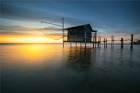 Typical fishing house in the adriatic coast at sunset, Marina di Ravenna, Emilia Romagna, Italy, Europe