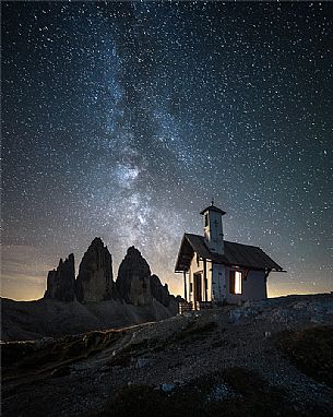 Milkyway over Tre Cime di Lavaredo peak and the small chapel, dolomites, Sexten, South Tyrol, Europe