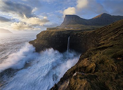 Coast with waterfall and village Gsedal or Gsadalur, Vgar Island (Vg), Faeroe Islands, Denmark, Europe