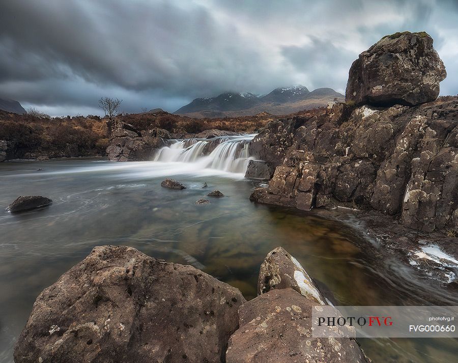 Sligachan waterfalls and the black cuillins in the background at sunset