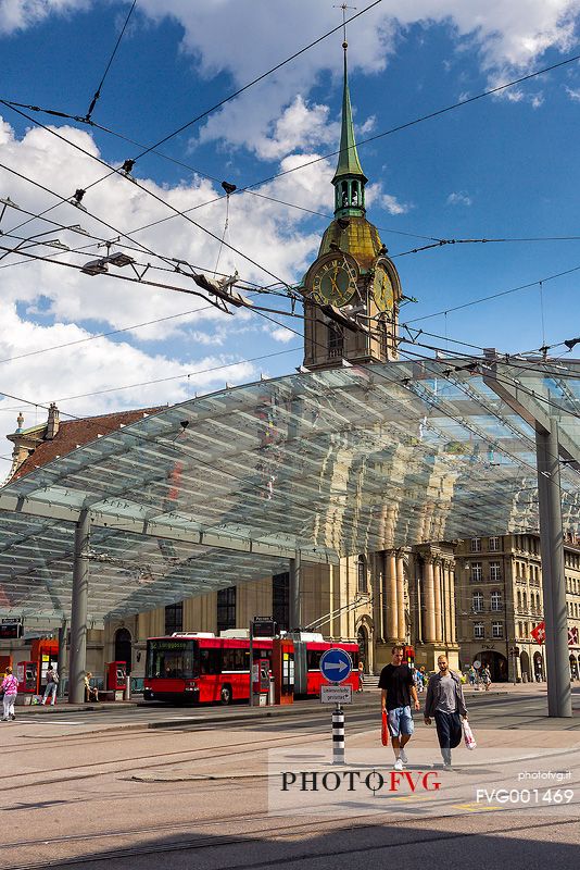 The modern covered tram and train station and in the background Holy Spirit Church or Heiliggeistkirche, Berne, Switzerland, Europe 