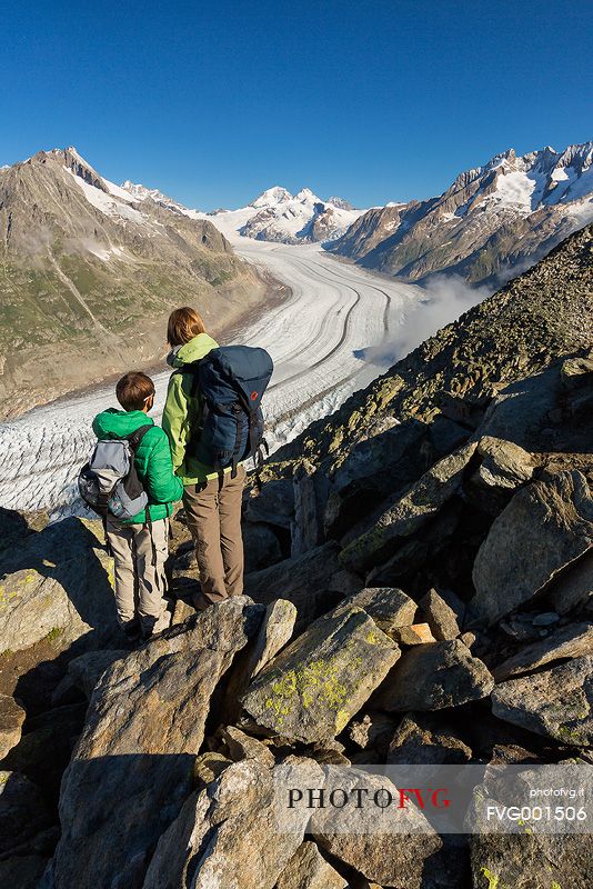 Mother and son at the Eggishorn mountain admiring the Aletsch glacier and Jungfrau mountains, Valais, Switzerland, Europe