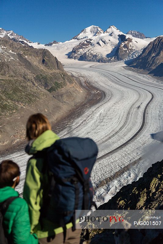 Mother and son at the Eggishorn mountain admiring the Aletsch glacier and Jungfrau mountains, Valais, Switzerland, Europe