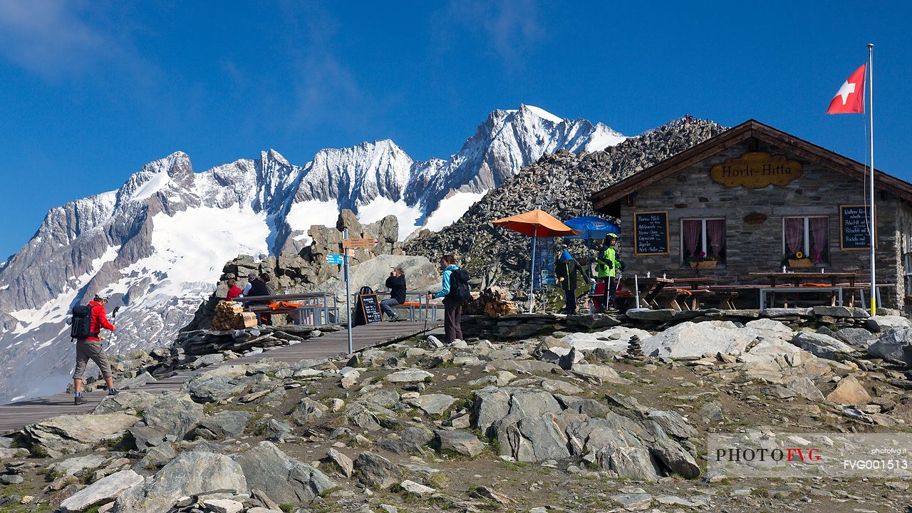 Hikers at the Horli Hitta mountain hut over Aletsch glacier, Eggishorn mountain, Fiesch,  Valais, Switzerland, Europe