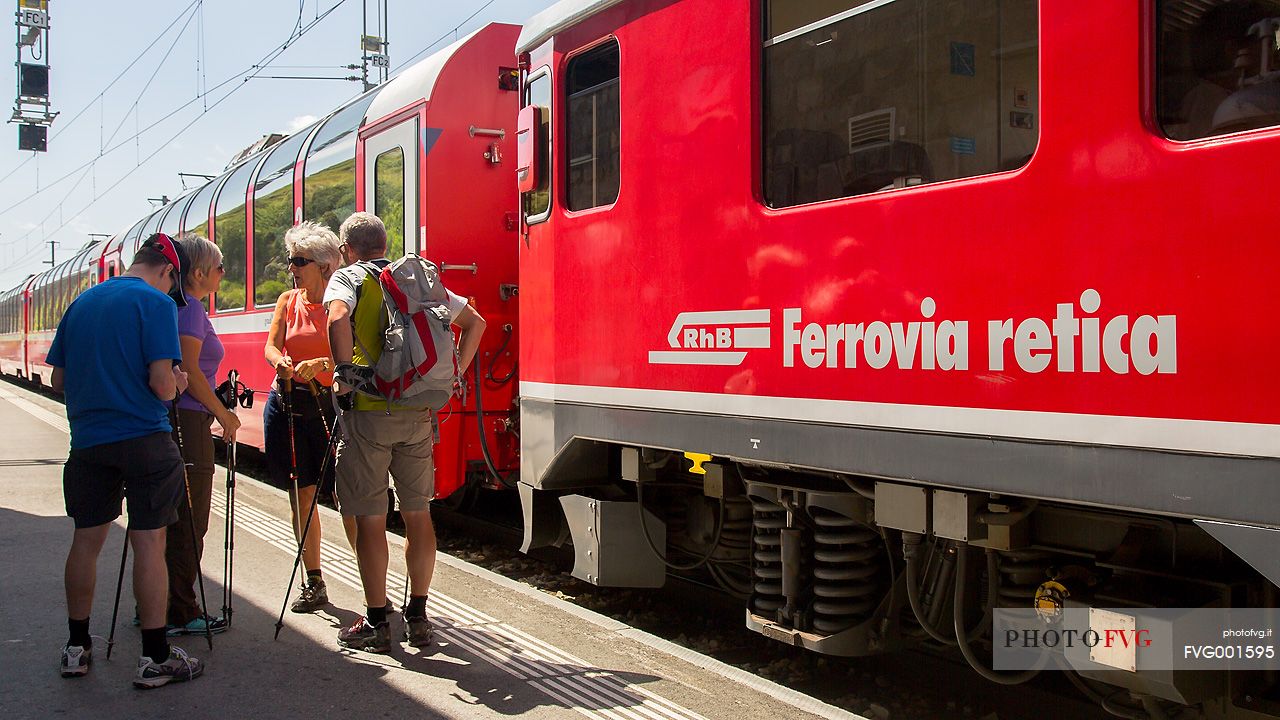 Tourists at the Bernina pass station with Bernina Express train, Rhetic railways, Engadin, Canton of Grisons, Switzerland, Europe