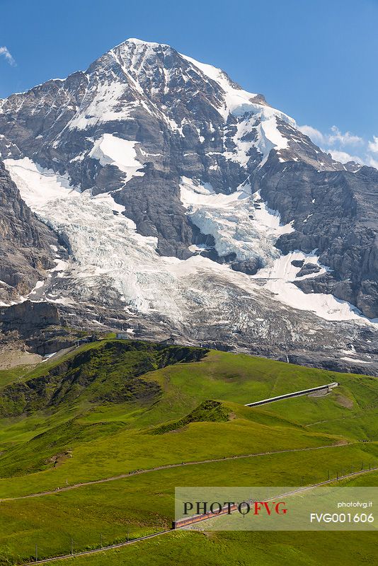 Typical swiss red train on Kleine Scheidegg, Jungfraujoch Railway, mountain pass between Eiger and Lauberhorn peaks, Grindelwald, Switzerland, Europe