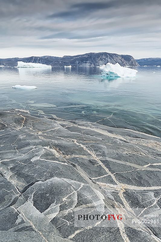 Reefs, sea with icebergs of Ataa a small village of
fishermen and seal hunters which was abandoned in the 50s