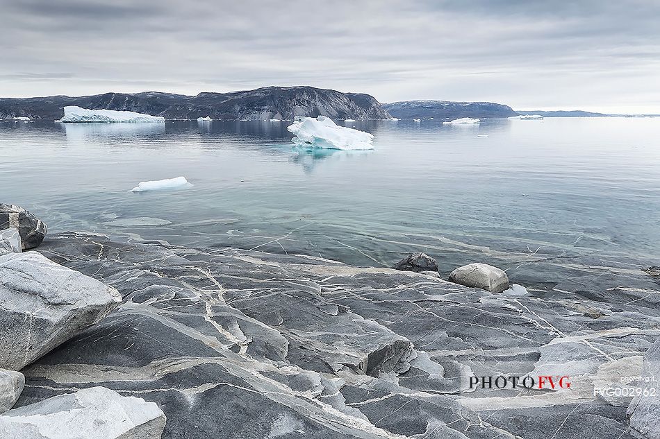 Reefs, sea with icebergs of Ataa a small village of
fishermen and seal hunters which was abandoned in the 50s