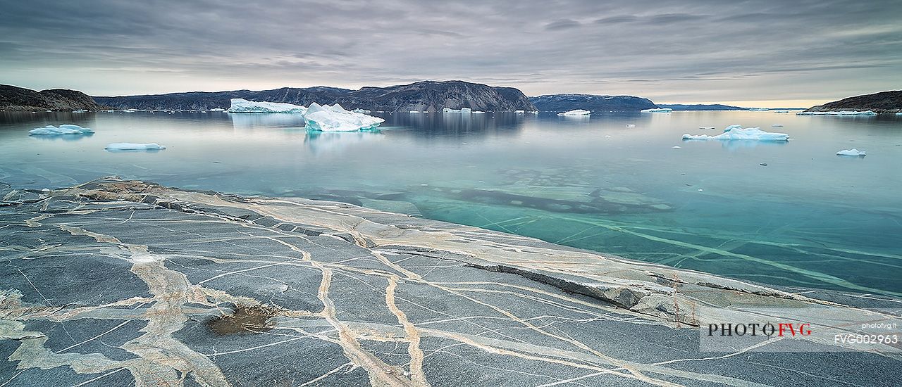 Reefs, sea with icebergs of Ataa a small village of
fishermen and seal hunters which was abandoned in the 50s