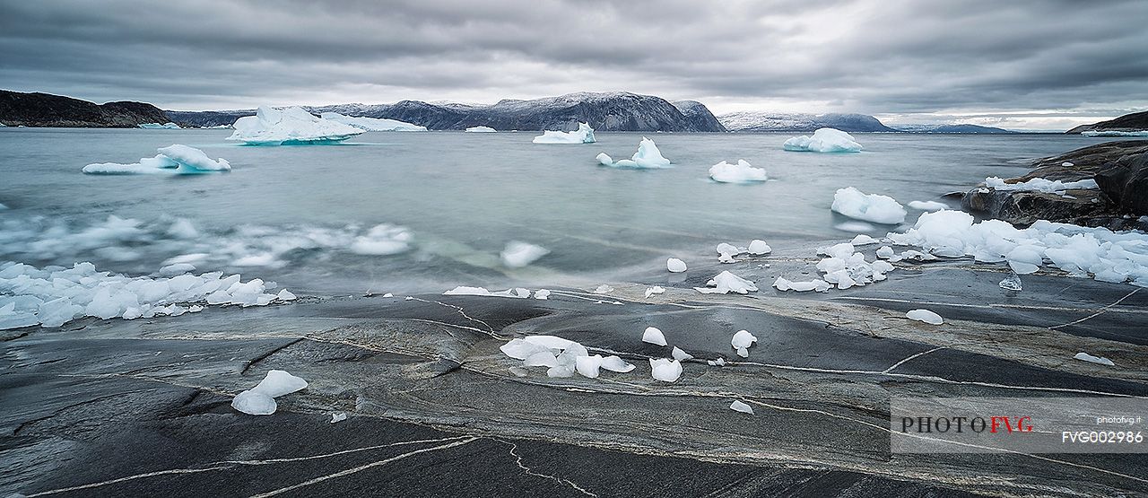 Reefs, sea with icebergs of Ataa a small village of
fishermen and seal hunters which was abandoned in the 50s