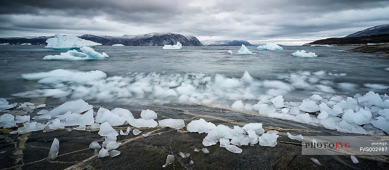 Reefs, sea with icebergs of Ataa a small village of
fishermen and seal hunters which was abandoned in the 50s