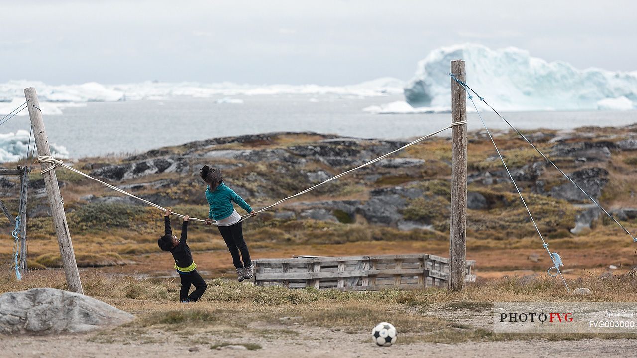 Children play in Rodebay a small village of fishermen and seal hunters in Disko Bay