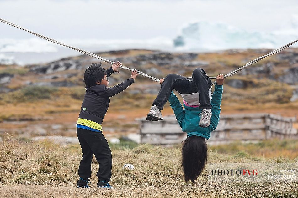 Children play in Rodebay a small village of fishermen and seal hunters in Disko Bay