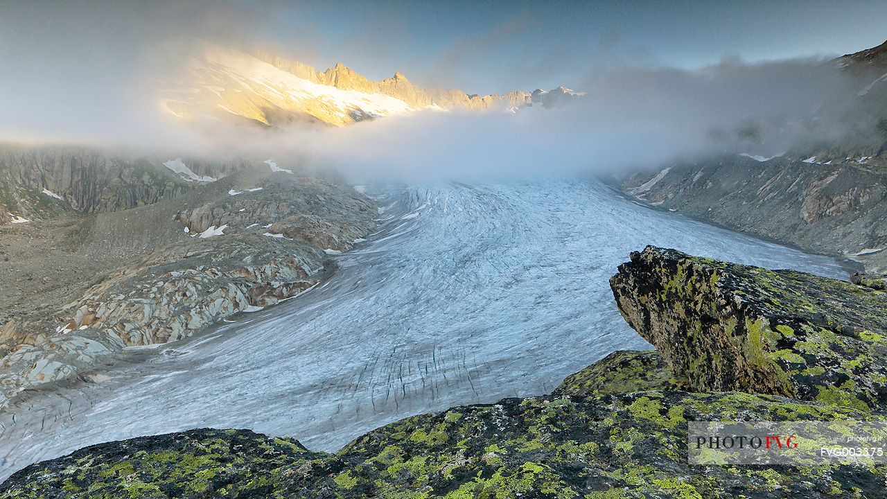 Rhone glacier in the mist of a clear morning dawn, Furka pass, Valais, Switzerland, Europe