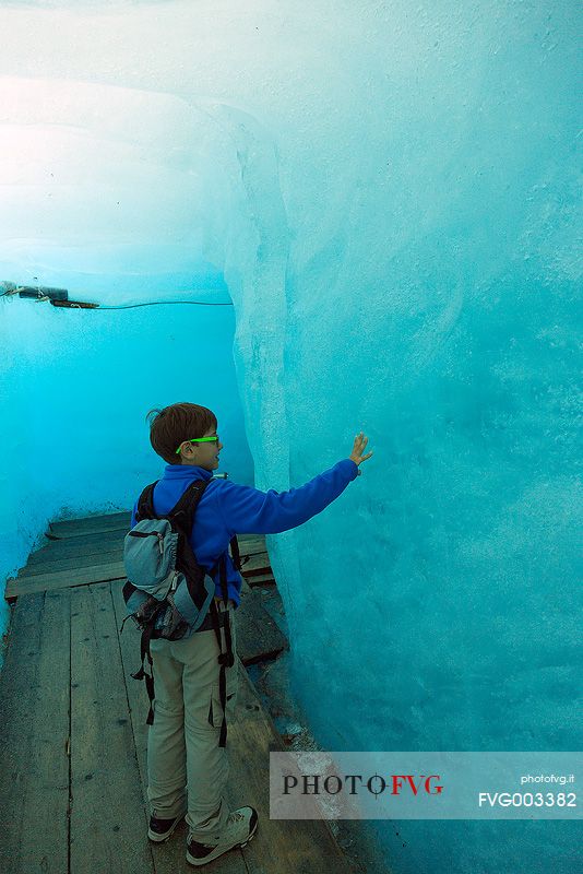 Child inside the Rhone glacier, Furka pass, Valais, Switzerland, Europe