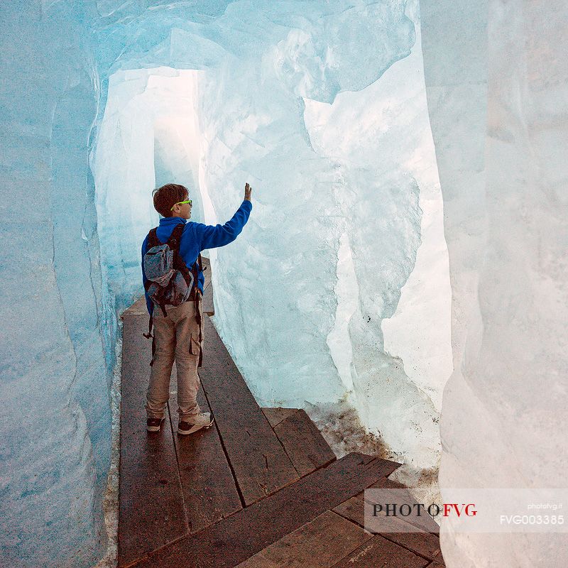 Child inside the Rhone glacier, Furka pass, Valais, Switzerland, Europe