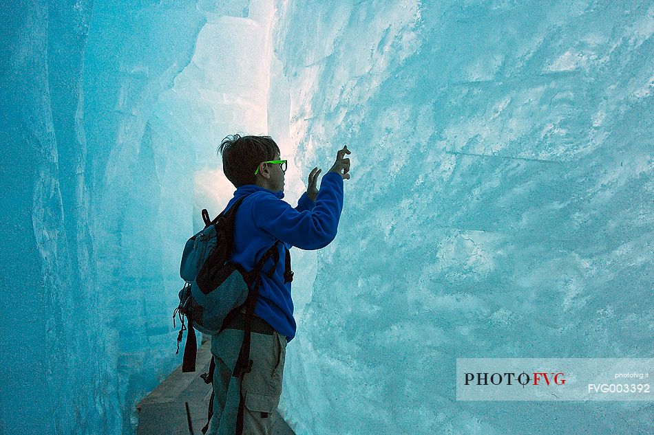 Child inside the Rhone glacier, Furka pass, Valais, Switzerland, Europe