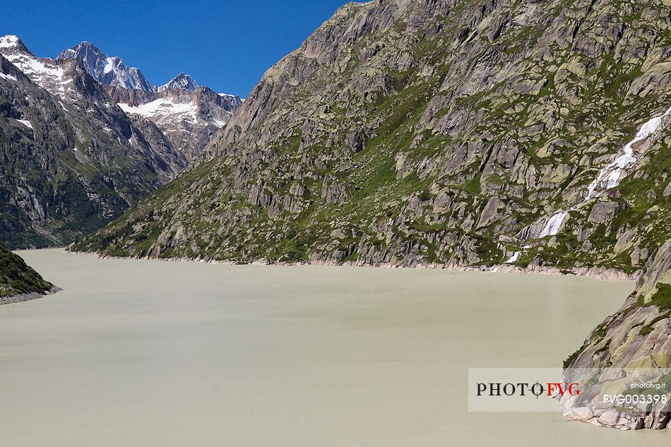 Grimselsee or Grisel lake and waterfall, Grimsel pass, Bernese alps, Switzerland, Europe