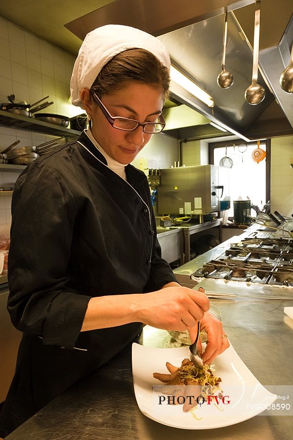 Chef working in the kitchen of Morgenleit restaurant, Sauris