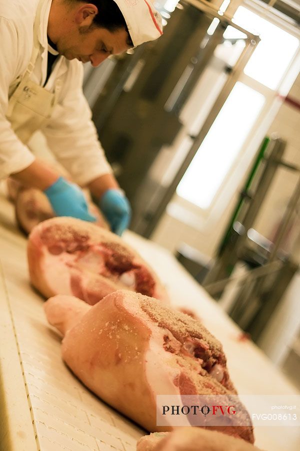 Processing hams in Wolf ham factory of Sauris