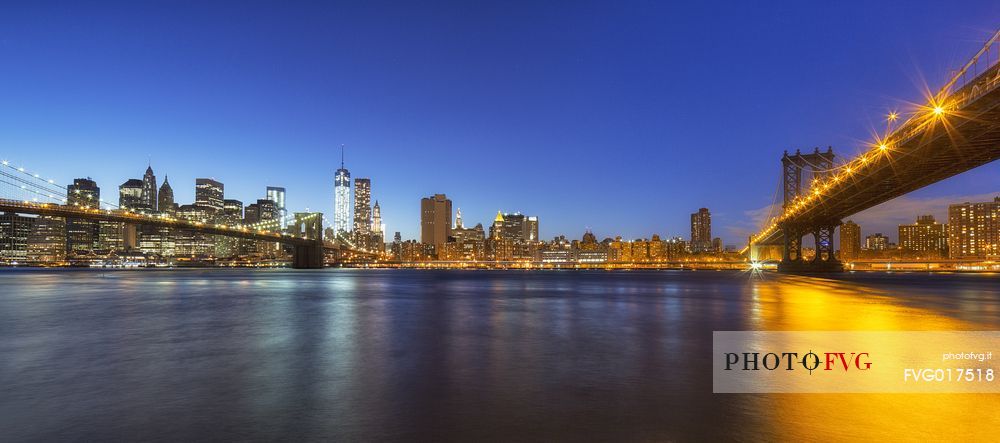 Manhattan skyline and Brooklyn  and Manhattan Bridge at evening