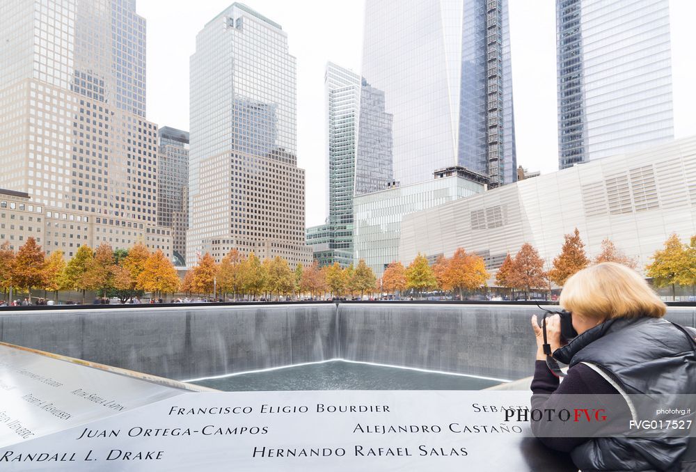 Woman shooting photos at Ground Zero memorial
