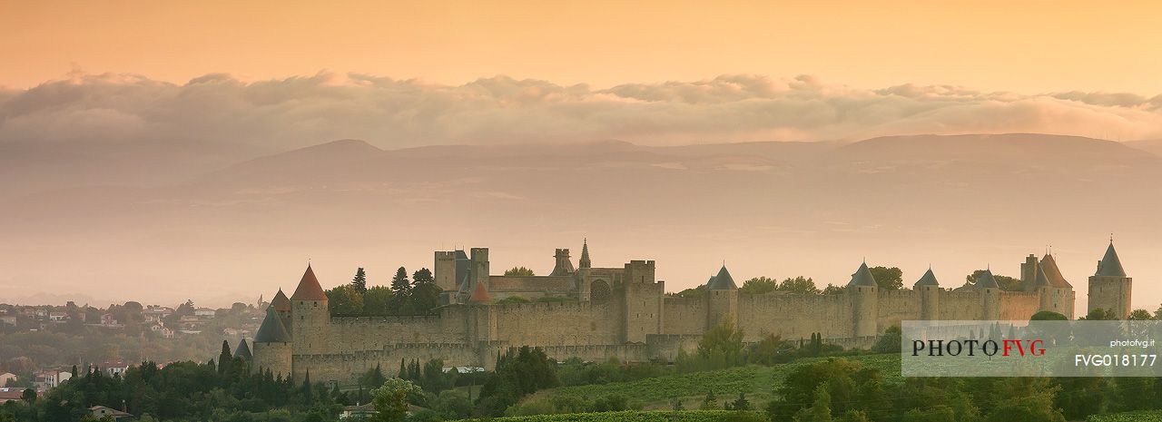 The mediavel ancient city of Carcassonne in warm light of sunrise