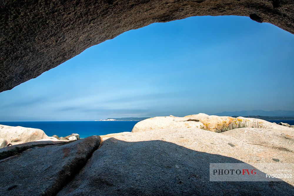 Stones in Lavezzi islands in natual reserve of Bocche di Bonifacio and in the background the island of Corsica and the white cliffs of Bonifacio