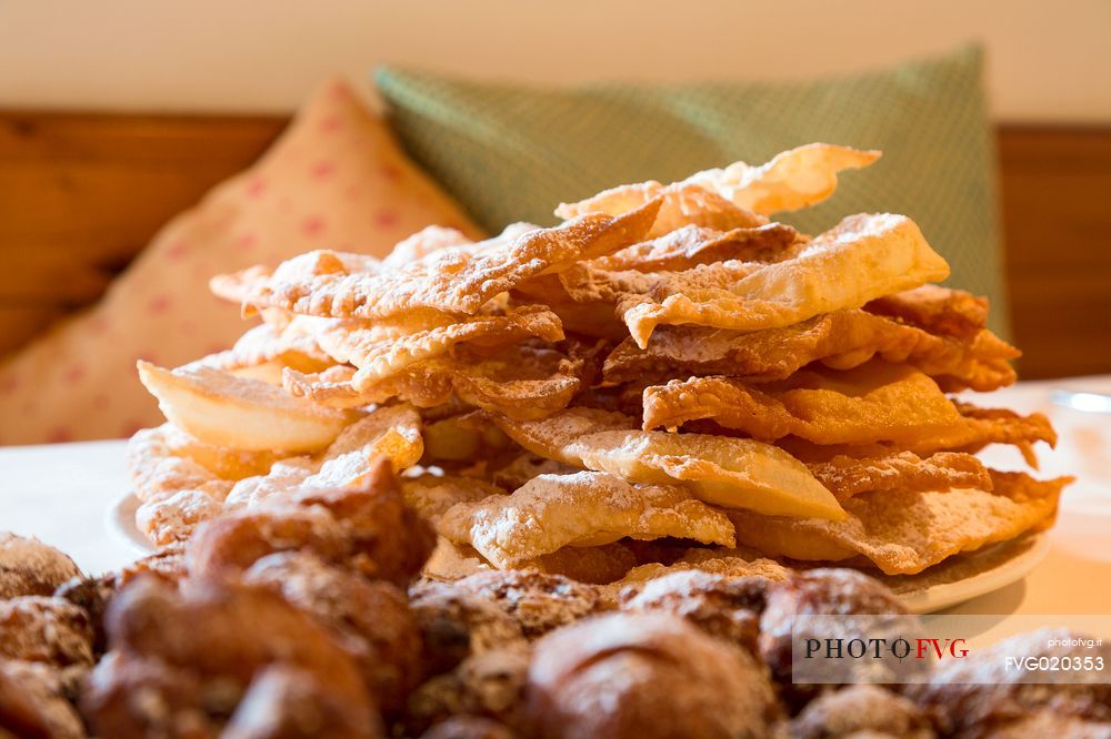 Crostoli and frittelle, typical cakes of the Carnival of Sauris one of the oldest and most characteristic of the Alps