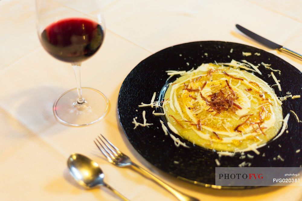 Polenta with cheese and crispy speck Sauris a typical dish served at the restaurant alla Pace of Sauris