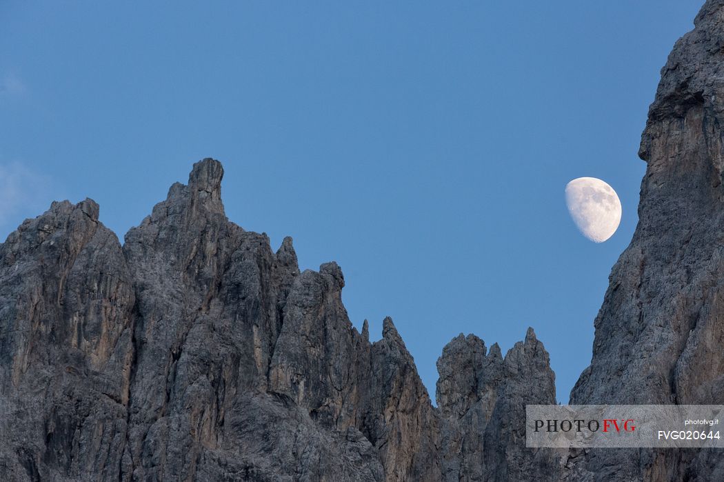 The moon rises on the Popera spiers in the Sesto Dolomites, from Berti refuge, Cadore, dolomites, Italy