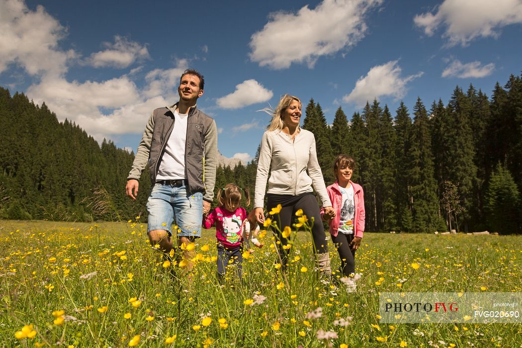 A family walks in Val Visdende, dolomites, Italy