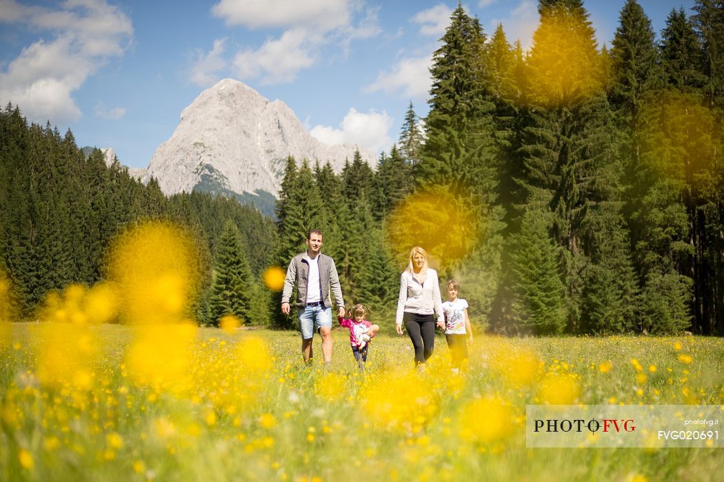 A family walks in Val Visdende, Comelico, Italy