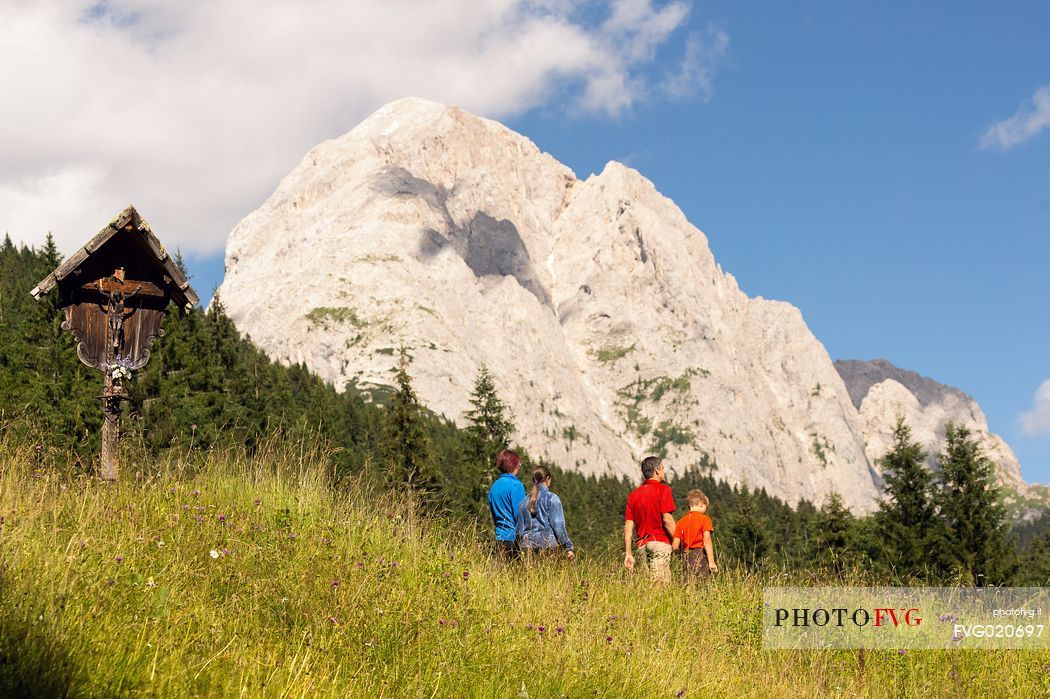 A family walks in Val Visdende, dolomites, Italy