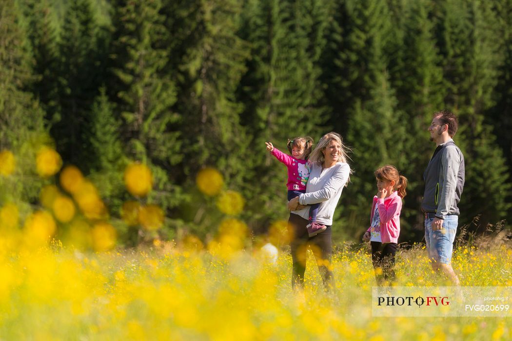 A family walks in Val Visdende, Comelico, Italy