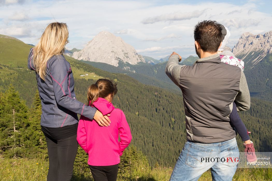 A family walks in Val Visdende, Comelico, Italy