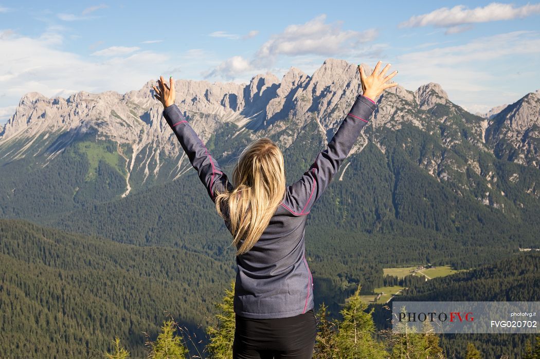 Hiker looks at the landscape from Val Visdende, Comelico, Italy