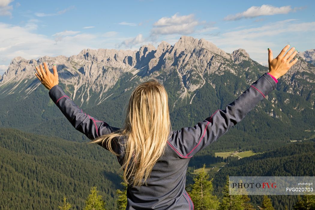 Hiker looks at the landscape from Val Visdende, Comelico, Italy