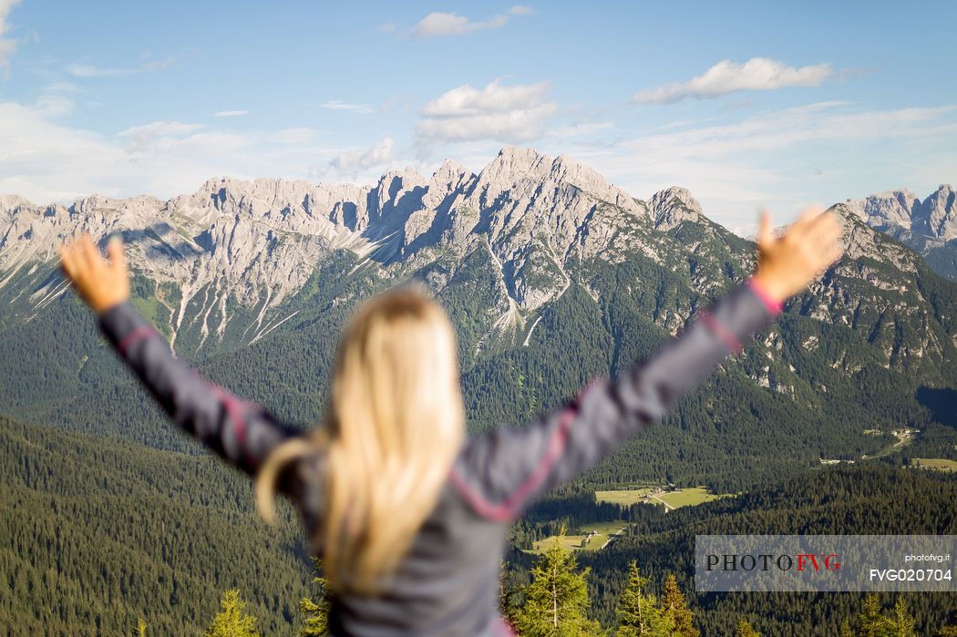 Hiker looks at the landscape from Val Visdende, Comelico, Italy