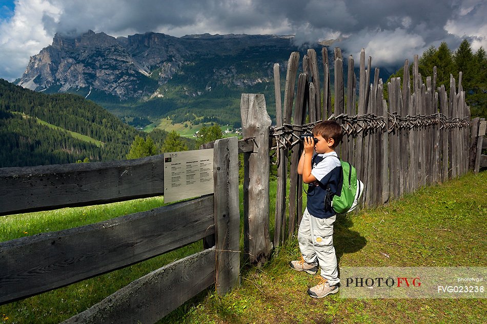 Child hiking in Badia Valley, South Tyrol, Dolomites, Italy