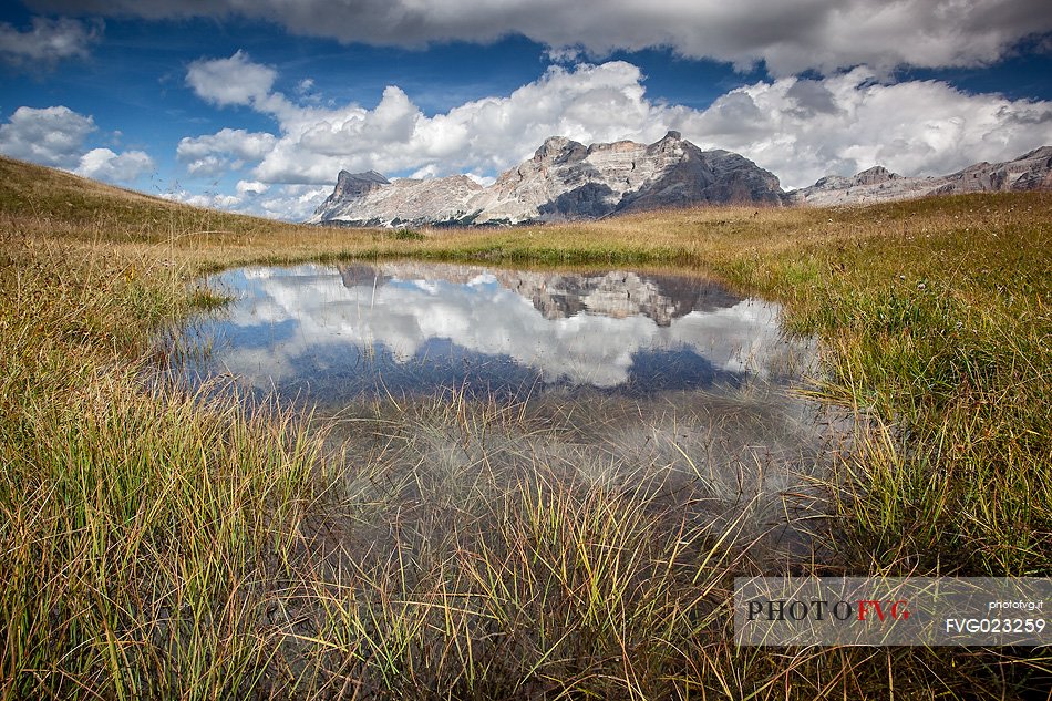 Lake in Pralongi in background the Sasso della Croce mountain, Val Badia, Dolomites, South Tyrol, Italy 